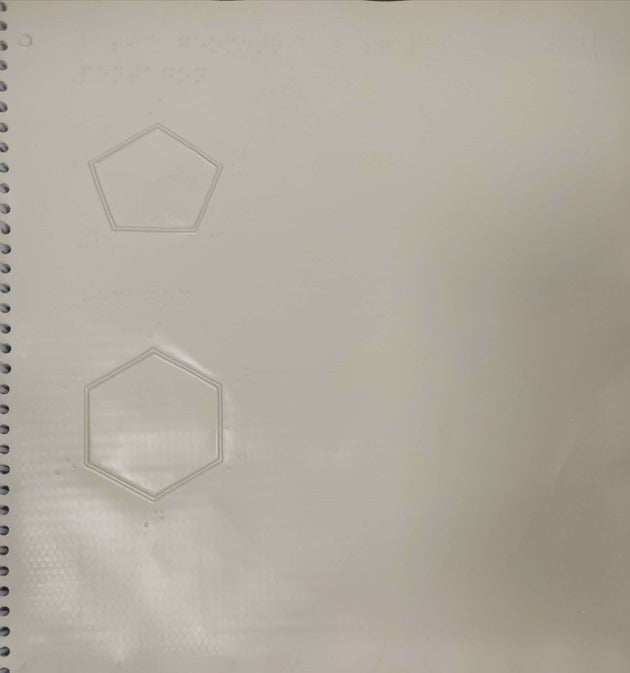 page from book with embossed pentagon and hexagon